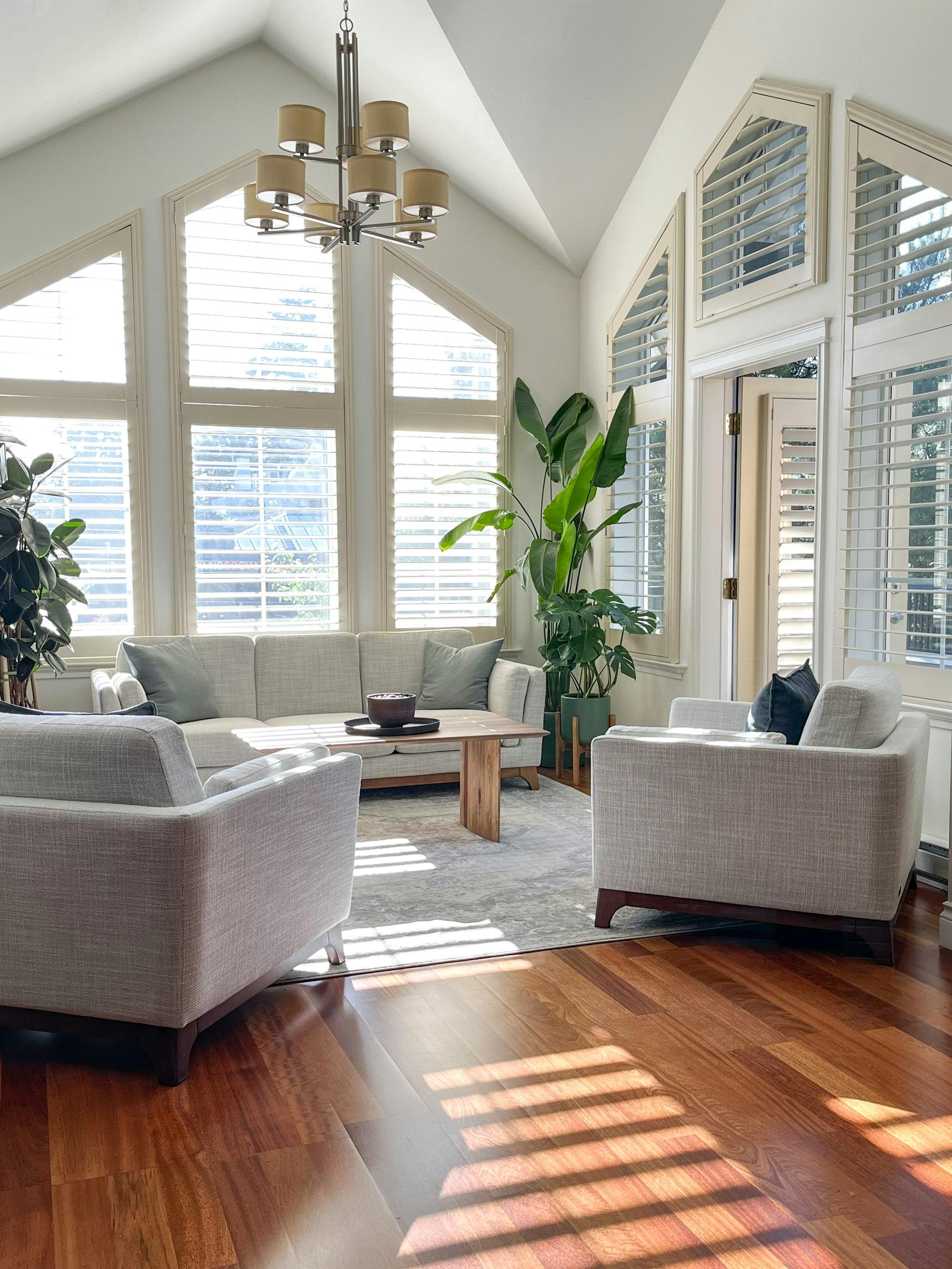 A bright, sunlit living room with warm wood floors